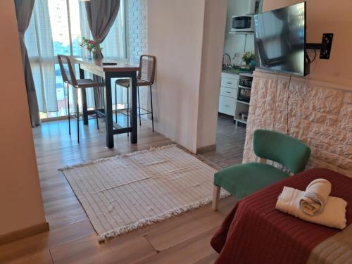 a room with a bed and a table and chairs at Monoambiente Puerto de Olivos in Olivos