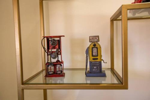 two toy clocks sitting on a glass shelf at Jardin Majorelle Cozy Apartment in Marrakech