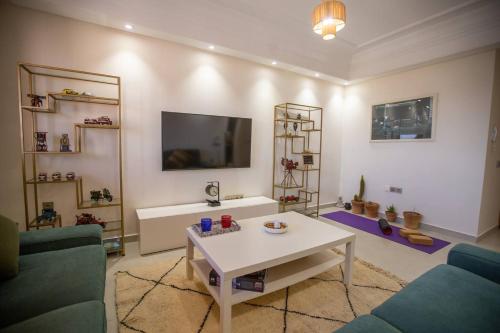 a living room with a couch and a table at Jardin Majorelle Cozy Apartment in Marrakech