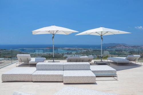 a group of couches and umbrellas on a patio at Mirage Ibiza in Ibiza Town