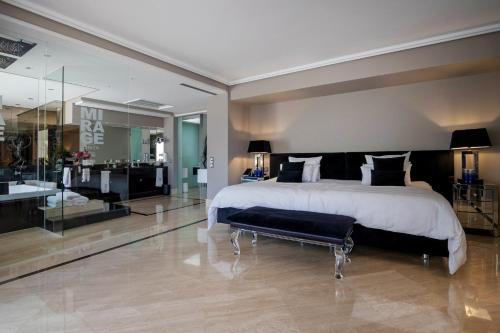 a large bedroom with a large bed and a bathroom at Mirage Ibiza in Ibiza Town
