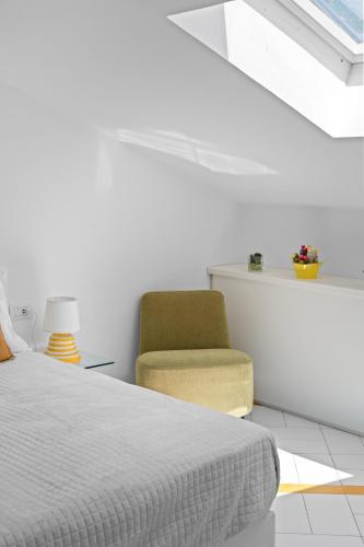 a bedroom with a bed and a chair at Torre Paradiso in Minori