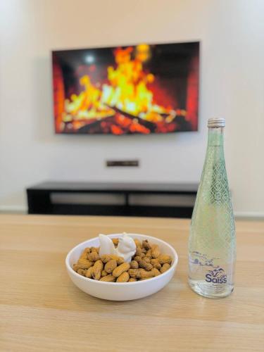 a bowl of peanuts and a bottle of soda at Majorelle Elegance City Center in Marrakech