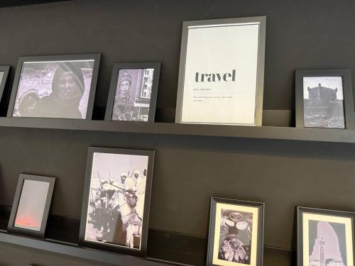 a shelf with pictures on it with at Majorelle Elegance City Center in Marrakech