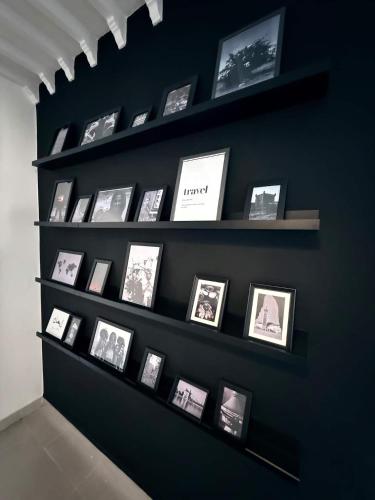 a display shelf with pictures on a wall at Majorelle Elegance City Center in Marrakech