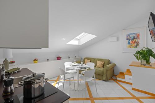 a kitchen and living room with a table and chairs at Torre Paradiso in Minori