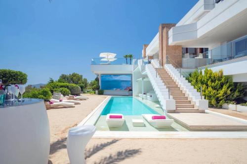a house with a swimming pool next to a building at Mirage Ibiza in Ibiza Town