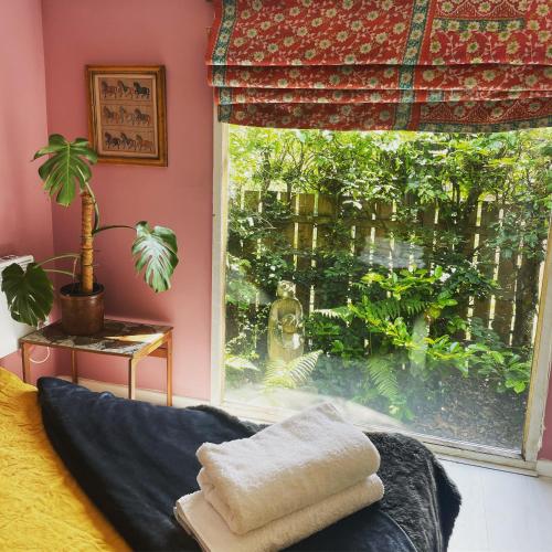 a room with a window and a couch with a blanket at The Deckhouse, cabin with big deck nr Hay-on-Wye in Rhos-gôch