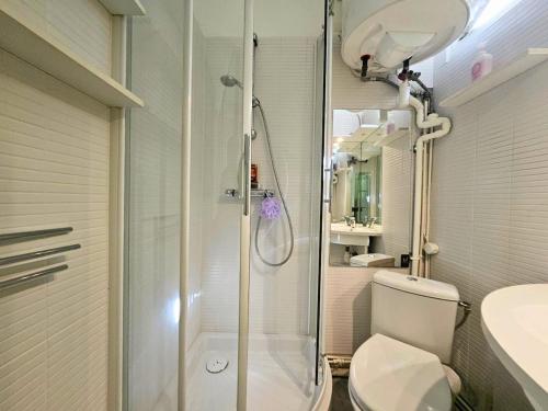 a bathroom with a shower and a toilet and a sink at Le Jardin Edgar Malakoff in Malakoff
