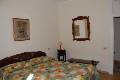 a bedroom with a bed and a mirror on the wall at Hotel Roma in Scanno