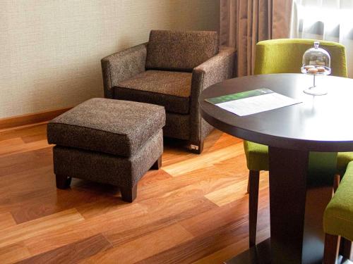 a room with a table and a chair and a stool at Manto Hotel Lima - MGallery Collection in Lima