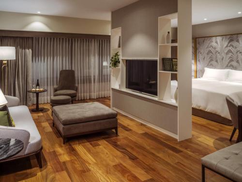 a hotel room with a bed and a tv at Manto Hotel Lima - MGallery Collection in Lima