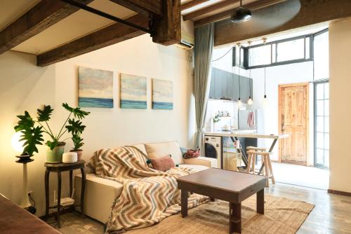 a living room with a couch and a table at duplex 1 bedroom apartment on Wuyuan Road close Changshu Road station in Shanghai