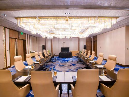 a large room with rows of tables and chairs at Admiral Hotel Manila - MGallery Collection in Manila