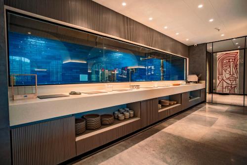 a bathroom with two sinks and a large window at Welina Hotel in Bhubaneshwar
