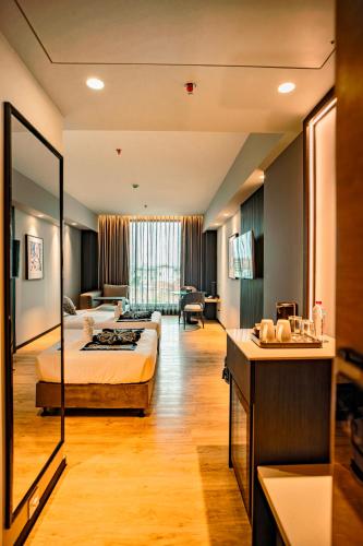 a hotel room with a bed and a living room at Welina Hotel in Bhubaneshwar