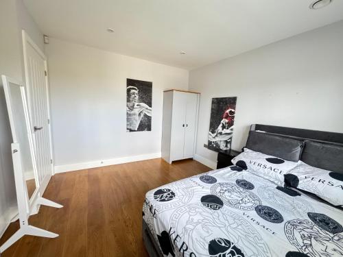 a bedroom with a bed with a black and white comforter at Double Room With Private Bathroom in Chatham in Chatham
