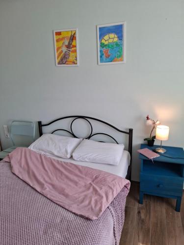 a bedroom with a bed and a table with a lamp at Elato apartment in Florina