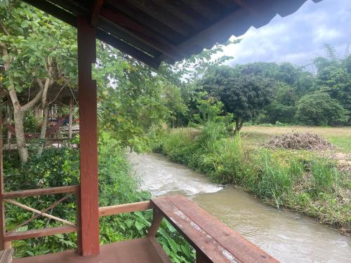a view of a river from a porch at Chiang Dao Hostel in Chiang Dao