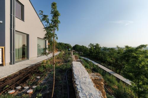 a house with a track next to a building at Two Doves House in Pohrebea