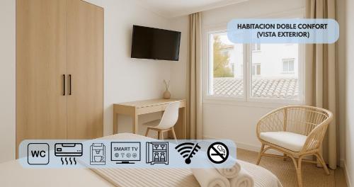 a bedroom with a bed and a television and a chair at Hotel y Apartamento Moli de Mar - Check-in 24 Horas in Lloret de Mar