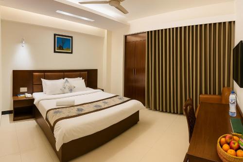 Ένα ή περισσότερα κρεβάτια σε δωμάτιο στο Ocean Palace Cox'sBazar