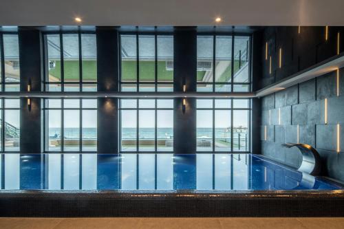 a pool in a building with a view of the ocean at Baltic View Resort & SPA, a member of Radisson Individuals in Międzyzdroje