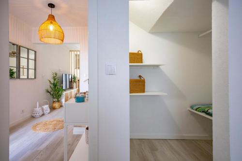 a room with white walls and a hallway with white shelves at Micului Refugiu in Albufeira