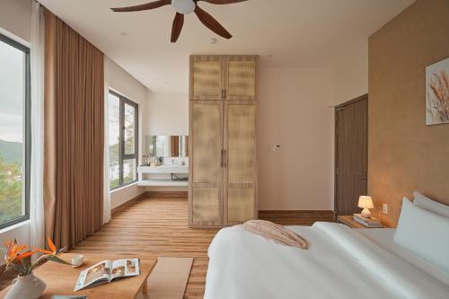 a bedroom with a bed and a ceiling fan at Yen Stay and Coffee in Da Lat
