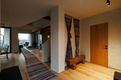 a living room with a staircase and a wooden door at Two Doves House in Pohrebea
