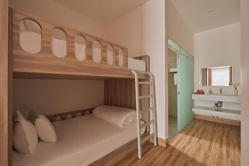a bunk bed with a ladder in a room at Yen Stay and Coffee in Da Lat