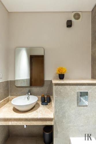 a bathroom with a sink and a mirror at Habitat Towers in Sheikh Zayed