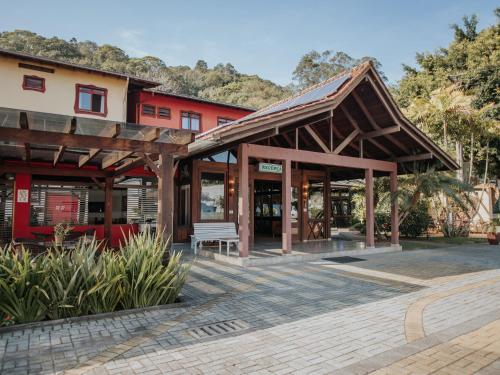 a wooden building with a bench in front of it at Hotel Raul's in Gaspar
