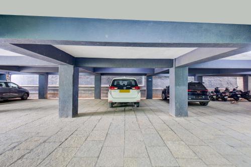 a white car parked in a parking lot at FabHotel Samudra Executive - Nr Solapur Highway in Pune
