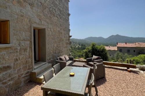 a table and chairs on a patio with a view at Casetta Tozza Di Conca in Conca