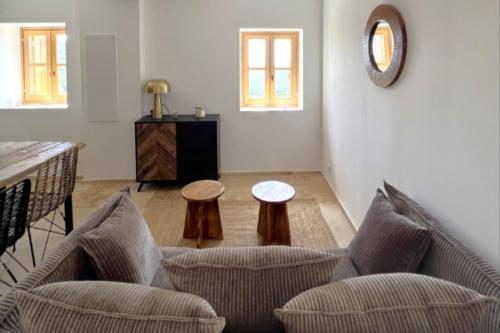 a living room with two chairs and a table at Casetta Tozza Di Conca in Conca