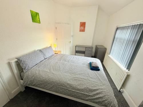 a bedroom with a bed and a window at BIG double room Attached Shower near to city center in Nottingham