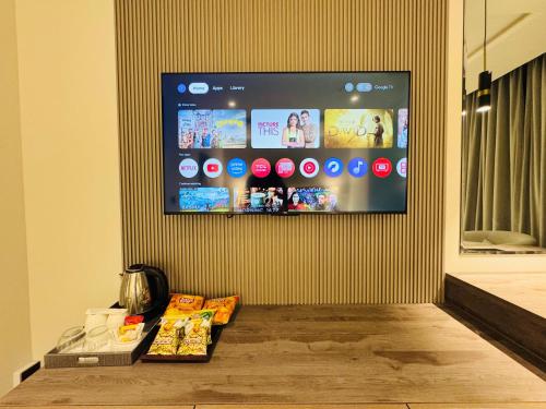 a flat screen tv hanging on a wall at Taj Hotel Premium Residency F-7 Islamabad in Islamabad