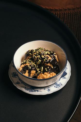 a bowl of food on a plate on a table at Komana Hotel Binbirdirek in Istanbul