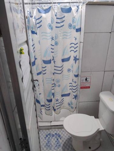 a bathroom with a toilet and a shower curtain at HOSTEL RAIZ da BAHIA in Salvador