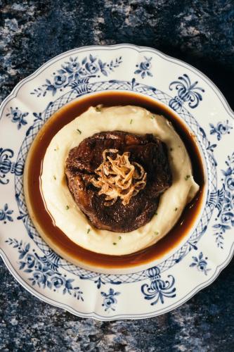 a bowl of food on a blue and white plate at Komana Hotel Binbirdirek in Istanbul