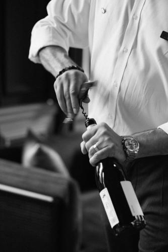 a man is holding a bottle of wine at Komana Hotel Binbirdirek in Istanbul