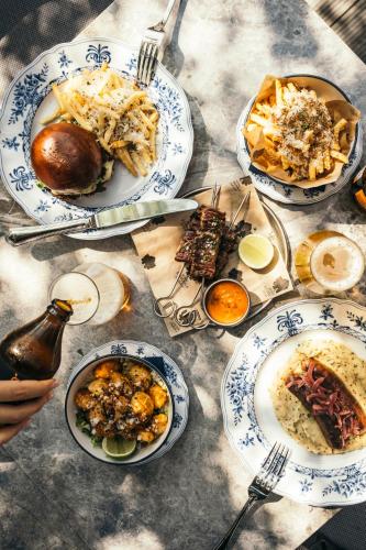 a table with plates of food on it at Komana Hotel Binbirdirek in Istanbul