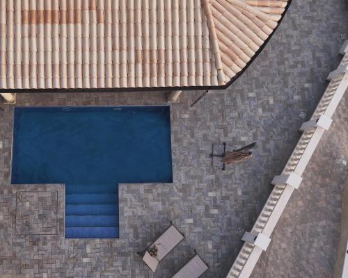an overhead view of a building with a swimming pool at Mariluna Luxury Apartments in Falconara Albanese