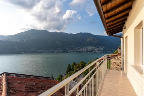 a balcony with a view of a body of water at DN ART ROYALE - APT N vasca idromassaggio interno piano terra -APT D esclusivo terrazzo esterno con jacuzzi in Blevio