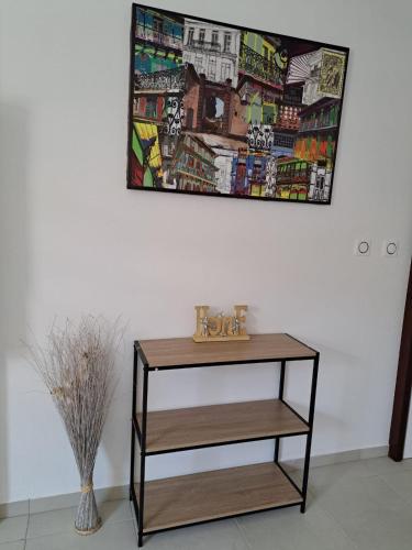 a table in a room with a painting on the wall at CAYENNE Centre Studio D'ESTREE ECO LUXE in Cayenne