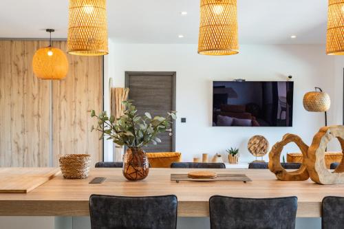 a dining room with a large wooden table and chairs at Villa Tinoeva Mare di Conca in Conca