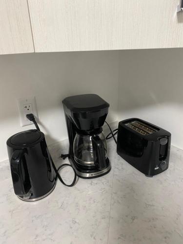 a blender and a toaster sitting on a counter at Cozy 2-Bedroom Suite in Aspen Ridge in Saskatoon