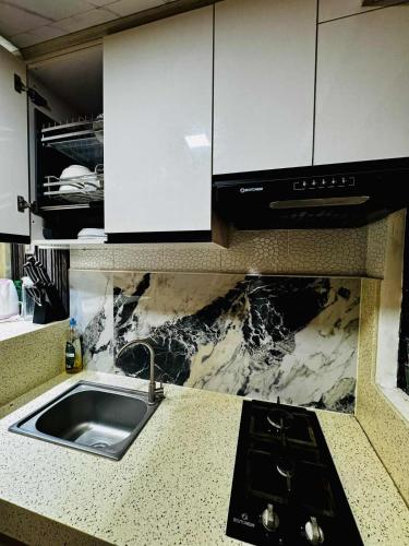 a kitchen with a sink and a counter top at Cozy Home in the heart of Mandaue City in Mandaue City