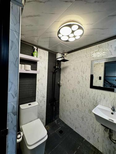 a bathroom with a toilet and a sink at Cozy Home in the heart of Mandaue City in Mandaue City